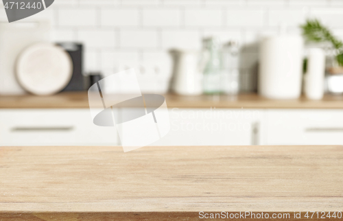 Image of wooden table and defocused kitchen background