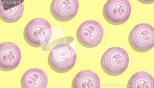 Image of onion slices on yellow background