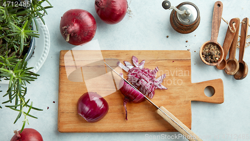 Image of chopped red onions on wooden cutting board