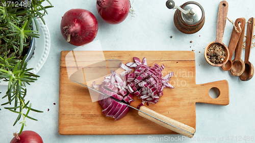 Image of chopped red onions on wooden cutting board