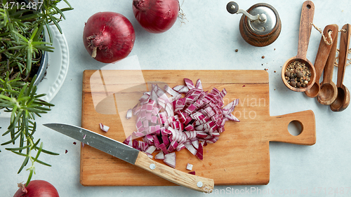 Image of chopped red onions on wooden cutting board