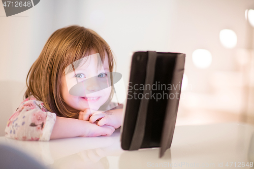 Image of child playing with digital tablet