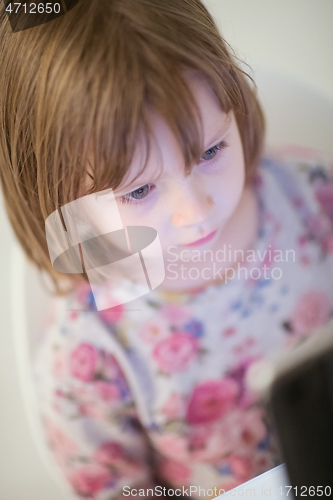 Image of child playing with digital tablet