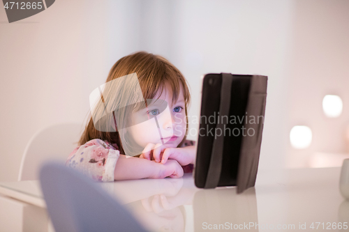 Image of child playing with digital tablet