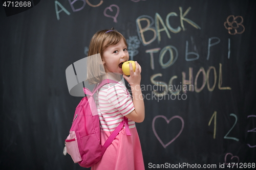 Image of happy child with apple and back to school drawing in background