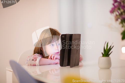 Image of child playing with digital tablet
