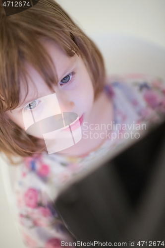Image of child playing with digital tablet
