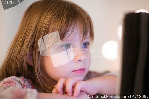 Image of child playing with digital tablet