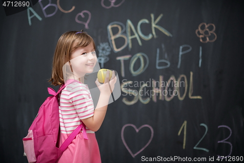 Image of happy child with apple and back to school drawing in background