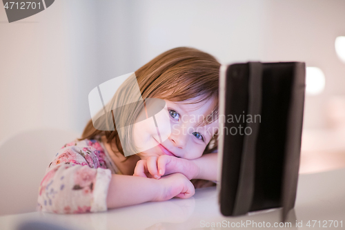 Image of child playing with digital tablet