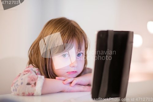 Image of child playing with digital tablet