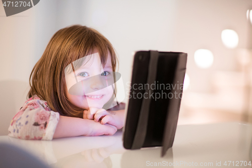 Image of child playing with digital tablet