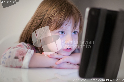 Image of child playing with digital tablet