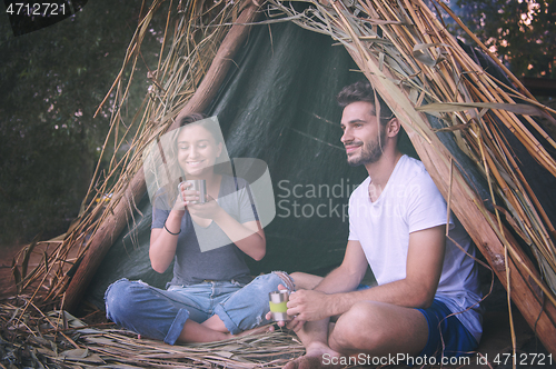 Image of couple spending time together in straw tent