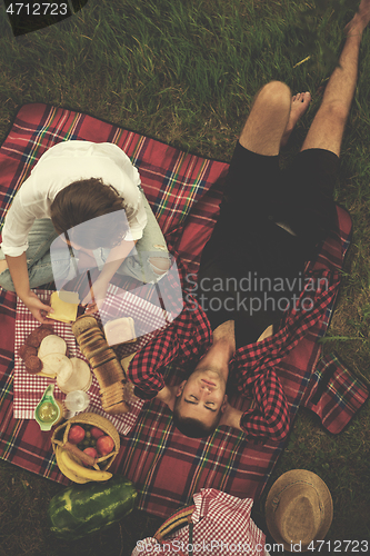 Image of top view of couple enjoying picnic time