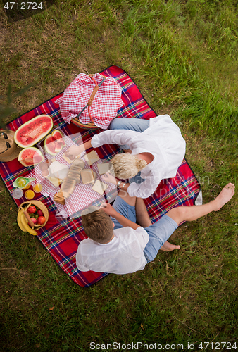 Image of top view of couple enjoying picnic time