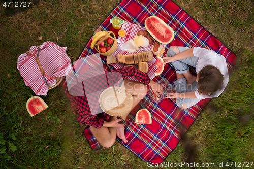Image of top view of couple enjoying picnic time