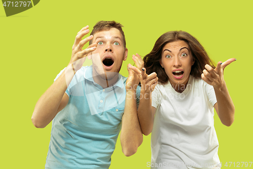 Image of Beautiful couple isolated on green studio background