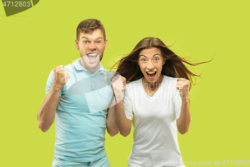 Image of Beautiful couple isolated on green studio background