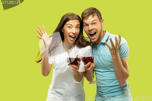 Image of Beautiful couple isolated on green studio background