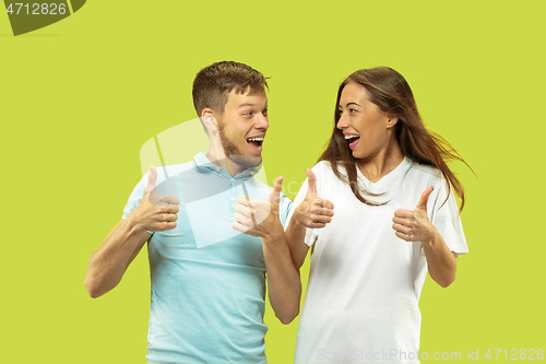 Image of Beautiful couple isolated on green studio background