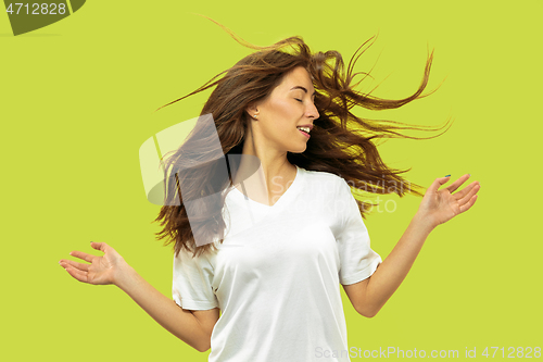 Image of Beautiful woman\'s portrait isolated on green studio background