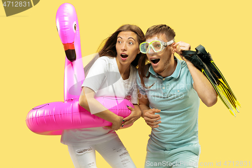 Image of Beautiful couple isolated on yellow studio background