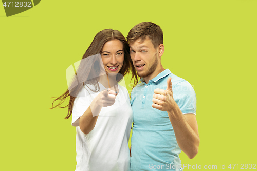 Image of Beautiful couple isolated on green studio background