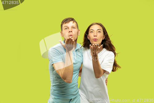 Image of Beautiful couple isolated on green studio background