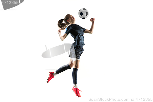 Image of Female soccer player kicking ball isolated over white background