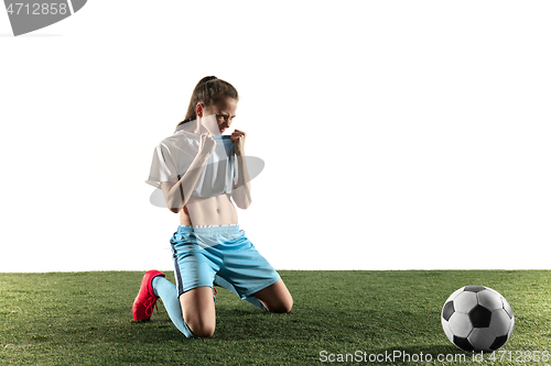 Image of Female soccer player sitting with the ball isolated over white background