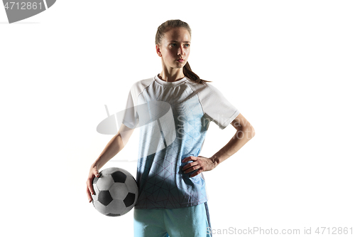 Image of Female soccer player standing with the ball isolated over white background
