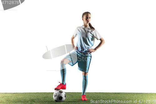 Image of Female soccer player standing with the ball isolated over white background