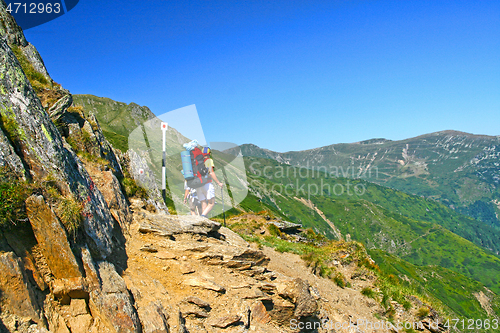 Image of Hiking teens on mountain trail