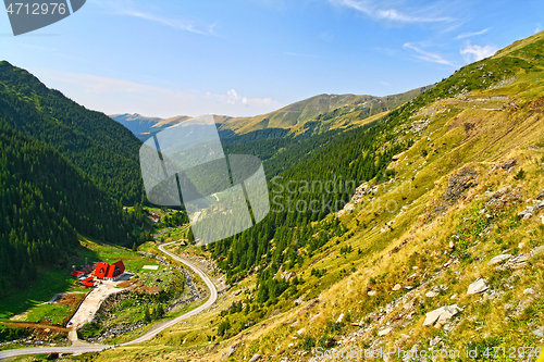 Image of Green alpine valley, chalet near the forest