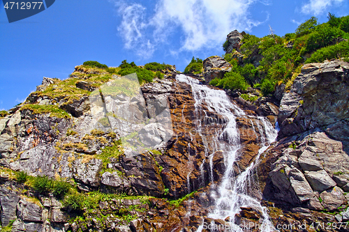 Image of Rocky waterfall in summer mountain