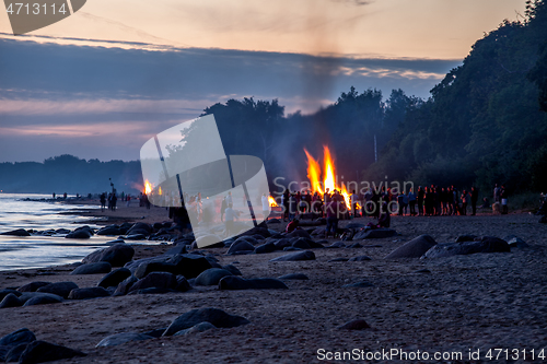 Image of Unrecognisable people celebrating summer solstice with bonfires 