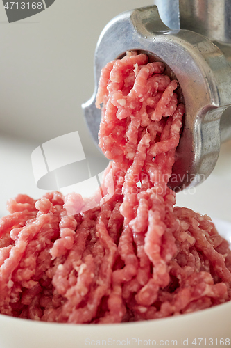 Image of mince the meat with an electric meat mincer