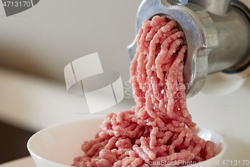 Image of mince the meat with an electric meat mincer