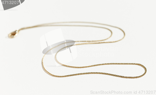 Image of gold chain on white background