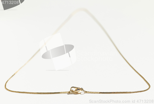 Image of gold chain on white background