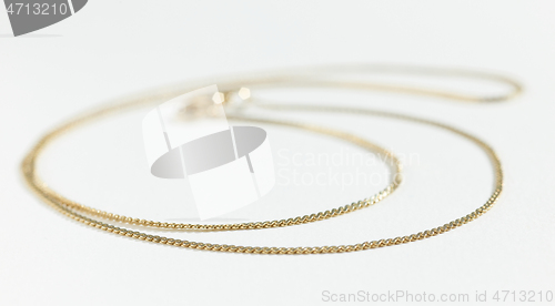 Image of gold chain on white background