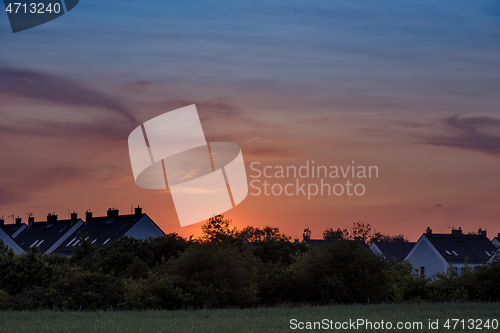 Image of Houses and trees at sunset