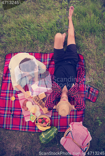 Image of top view of couple enjoying picnic time