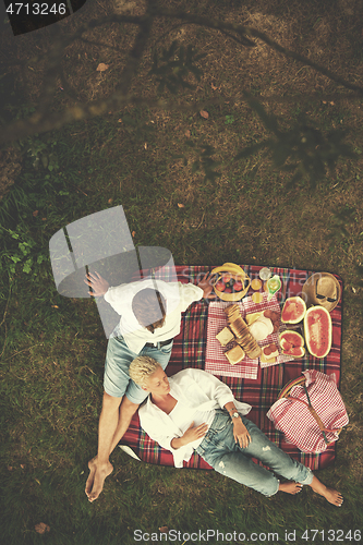 Image of top view of couple enjoying picnic time