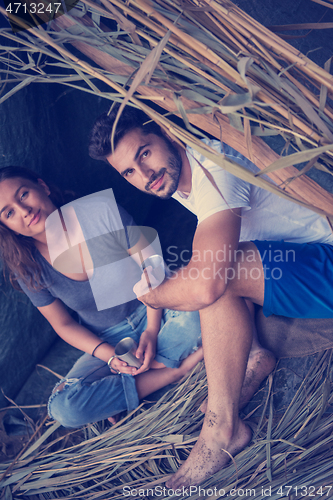 Image of couple spending time together in straw tent