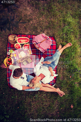 Image of top view of couple enjoying picnic time