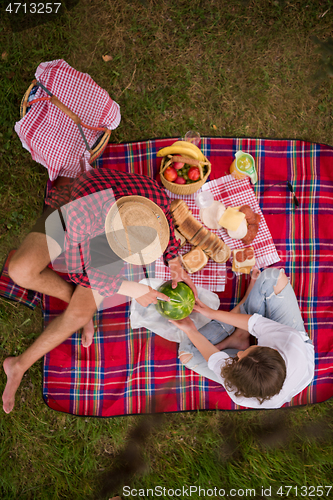 Image of top view of couple enjoying picnic time