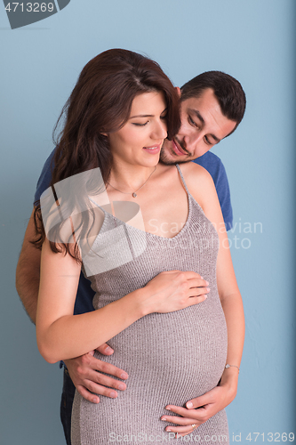 Image of pregnant couple  isolated over blue background
