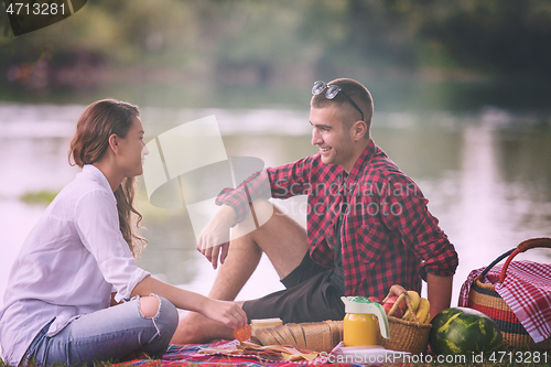 Image of Couple in love enjoying picnic time